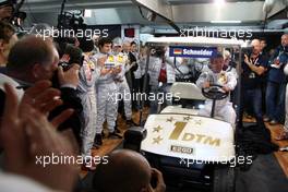 26.10.2008 Hockenheim, Germany,  On the occassion of the very last DTM race of Bernd Schneider, all the DTM drivers gathered in his pitbox. As as farewell present he received a customized golf card. - DTM 2008 at Hockenheimring, Germany
