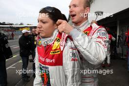 26.10.2008 Hockenheim, Germany,  (right) Alexandre Premat (FRA), Audi Sport Team Phoenix, Audi A4 DTM in a playful mood with Katherine Legge (GBR), TME, Audi A4 DTM. He was trying to lift her with the safety straps on her race overall. Legge definitely didn't appreciate the joke..... - DTM 2008 at Hockenheimring, Germany