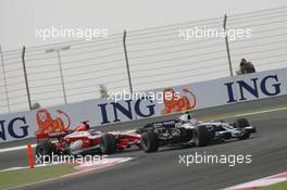 06.04.2008 Sakhir, Bahrain,  Kazuki Nakajima (JPN), Williams F1 Team, FW30 leads Takuma Sato (JPN), Super Aguri F1, SA08 - Formula 1 World Championship, Rd 3, Bahrain Grand Prix, Sunday Race