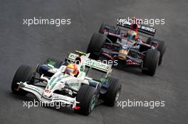 02.11.2008 Sao Paulo, Brazil,  Rubens Barrichello (BRA), Honda Racing F1 Team, RA108 leads Sebastian Bourdais (FRA), Scuderia Toro Rosso, STR03 - Formula 1 World Championship, Rd 18, Brazilian Grand Prix, Sunday Race