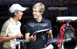 16.10.2008 Shanghai, China,  Eva Steinberger (AUT), Golfer and Sebastian Vettel (GER), Scuderia Toro Rosso - Formula 1 World Championship, Rd 17, Chinese Grand Prix, Thursday