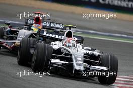22.06.2008 Magny Cours, France,  Kazuki Nakajima (JPN), Williams F1 Team leads Sebastian Bourdais (FRA), Scuderia Toro Rosso - Formula 1 World Championship, Rd 8, French Grand Prix, Sunday Race