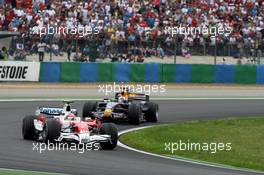 22.06.2008 Magny Cours, France,  Timo Glock (GER), Toyota F1 Team leads David Coulthard (GBR), Red Bull Racing - Formula 1 World Championship, Rd 8, French Grand Prix, Sunday Race