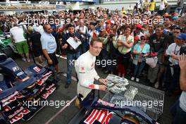19.06.2008 Magny Cours, France,  Sebastian Bourdais (FRA), Scuderia Toro Rosso signs autographs - Formula 1 World Championship, Rd 8, French Grand Prix, Thursday