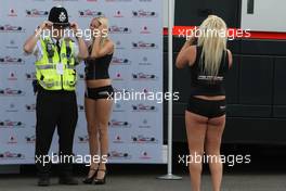 04.07.2008 Silverstone, England,  Girls in the paddock have their picture taken with Police - Formula 1 World Championship, Rd 9, British Grand Prix, Friday