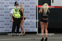 04.07.2008 Silverstone, England,  Girls in the paddock have their picture taken with Police - Formula 1 World Championship, Rd 9, British Grand Prix, Friday