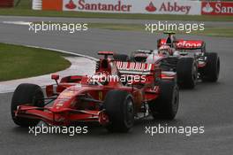 06.07.2008 Silverstone, England,  Kimi Raikkonen (FIN), Räikkönen, Scuderia Ferrari, F2008 and Heikki Kovalainen (FIN), McLaren Mercedes, MP4-23 - Formula 1 World Championship, Rd 9, British Grand Prix, Sunday Race