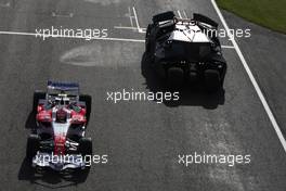 03.07.2008 Silverstone, England,  Timo Glock (GER), Toyota F1 Team, driving alongside the "Batmobile" , part of the sponsorship of the movie Batman "The Dark Knight" - Formula 1 World Championship, Rd 9, British Grand Prix, Thursday