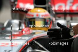 22.03.2008 Kuala Lumpur, Malaysia,  McLaren Mercedes, mechanics glove with Lewis Hamilton (GBR), McLaren Mercedes in the background - Formula 1 World Championship, Rd 2, Malaysian Grand Prix, Saturday Practice