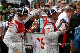 17.05.2009 Hockenheim, Germany,  (left) Oliver Jarvis (GBR), Audi Sport Team Phoenix, Audi A4 DTM pouring water in the race suit of (right) Tom Kristensen (DNK), Audi Sport Team Abt, Audi A4 DTM - DTM 2009 at Hockenheimring, Germany