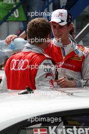 17.05.2009 Hockenheim, Germany,  (right) Oliver Jarvis (GBR), Audi Sport Team Phoenix, Audi A4 DTM pouring water in the racesuit of (left) Tom Kristensen (DNK), Audi Sport Team Abt, Audi A4 DTM - DTM 2009 at Hockenheimring, Germany