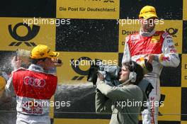 16.08.2009 Nürburg, Germany,  A local camera man in the middle of the champaign fight of Martin Tomczyk (GER), Audi Sport Team Abt, Portrait (1st, right) and Mattias Ekström (SWE), Audi Sport Team Abt, Portrait (3rd, left) - DTM 2009 at Nürburgring, Germany