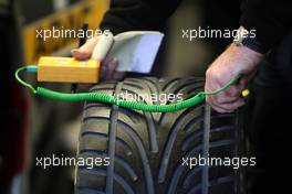 24.10.2009 Hockenheim, Germany,  Dunlop mechanic checking the tyre temperature. - DTM 2009 at Hockenheimring, Hockenheim, Germany