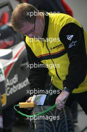 24.10.2009 Hockenheim, Germany,  tyre technician measures the temperatur on a DTM-tyre - DTM 2009 at Hockenheimring, Hockenheim, Germany