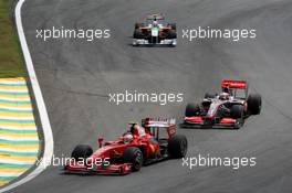 18.10.2009 Sao Paulo, Brazil,  Giancarlo Fisichella (ITA), Scuderia Ferrari leads Heikki Kovalainen (FIN), McLaren Mercedes - Formula 1 World Championship, Rd 16, Brazilian Grand Prix, Sunday Race