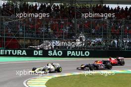 18.10.2009 Sao Paulo, Brazil,  Rubens Barrichello (BRA), BrawnGP leads Mark Webber (AUS), Red Bull Racing at the start - Formula 1 World Championship, Rd 16, Brazilian Grand Prix, Sunday Race