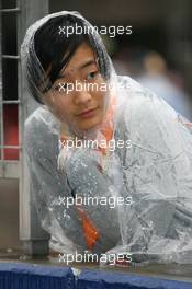 19.04.2009 Shanghai, China,  A girl with rain cover - Formula 1 World Championship, Rd 3, Chinese Grand Prix, Sunday
