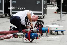 16.04.2009 Shanghai, China,  BMW mechanic with fuel hose - Formula 1 World Championship, Rd 3, Chinese Grand Prix, Thursday