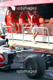 21.08.2009 Valencia, Spain,  Lewis Hamilton (GBR), McLaren Mercedes passes Michael Schumacher (GER), Test Driver, Scuderia Ferrari on the pit wall - Formula 1 World Championship, Rd 11, European Grand Prix, Friday Practice