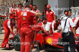 21.08.2009 Valencia, Spain,  Michael Schumacher (GER), Test Driver, Scuderia Ferrari looks at the car of Kimi Raikkonen (FIN), Räikkönen, Scuderia Ferrari - Formula 1 World Championship, Rd 11, European Grand Prix, Friday Practice
