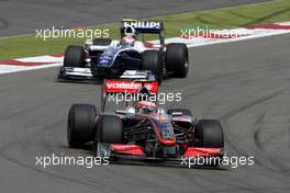 12.07.2009 Nürburg, Germany,  Heikki Kovalainen (FIN), McLaren Mercedes, MP4-24 leads Kazuki Nakajima (JPN), Williams F1 Team, FW31 - Formula 1 World Championship, Rd 9, German Grand Prix, Sunday Race