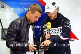 12.07.2009 Nürburg, Germany,  Lukas Podolski (soccer player) visits the garage of BMW and talks with Robert Kubica (POL),  BMW Sauber F1 Team - Formula 1 World Championship, Rd 9, German Grand Prix, Sunday