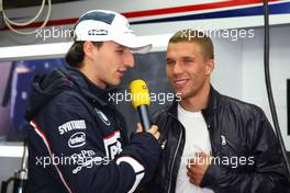 12.07.2009 Nürburg, Germany,  Lukas Podolski (soccer player) visits the garage of BMW and talks with Robert Kubica (POL),  BMW Sauber F1 Team - Formula 1 World Championship, Rd 9, German Grand Prix, Sunday