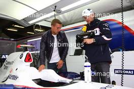 12.07.2009 Nürburg, Germany,  Lukas Podolski (soccer player) visits the garage of BMW and talks with Robert Kubica (POL),  BMW Sauber F1 Team - Formula 1 World Championship, Rd 9, German Grand Prix, Sunday