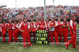 26.07.2009 Budapest, Hungary, The Team of Felipe Massa (BRA), Scuderia Ferrari stands with an sign on the grid to show that they are with Felipe in the hospital after his bad crash yesterday in Qualifying - Formula 1 World Championship, Rd 10, Hungarian Grand Prix, Sunday Pre-Race Grid