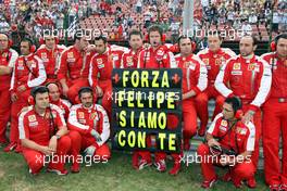 26.07.2009 Budapest, Hungary,  The Team of Felipe Massa (BRA), Scuderia Ferrari stands with an sign on the grid to show that they are with Felipe in the hospital after his bad crash yesterday in Qualifying - Formula 1 World Championship, Rd 10, Hungarian Grand Prix, Sunday Pre-Race Grid
