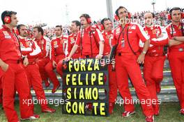 26.07.2009 Budapest, Hungary, The Team of Felipe Massa (BRA), Scuderia Ferrari stands with an sign on the grid to show that they are with Felipe in the hospital after his bad crash yesterday in Qualifying - Formula 1 World Championship, Rd 10, Hungarian Grand Prix, Sunday Pre-Race Grid