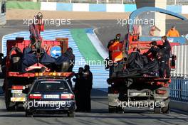 01.12.2009 Jerez, Spain,  The cars of Brendon Hartley  (NZL), Tests for Scuderia Toro Rosso and Daniel Ricciardo (AUS), Tests for Red Bull Racing are returned to the pits after the both stopped on track - Formula 1 Testing, Jerez