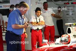 02.10.2009 Suzuka, Japan,  Joe Bauer of the FIA times Kamui Kobayashi, Test Driver, Toyota F1 Team getting out of the car - Formula 1 World Championship, Rd 15, Japanese Grand Prix, Friday