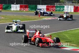 04.10.2009 Suzuka, Japan,  Kimi Raikkonen (FIN), Räikkönen, Scuderia Ferrari leads Rubens Barrichello (BRA), BrawnGP - Formula 1 World Championship, Rd 15, Japanese Grand Prix, Sunday Race
