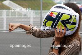 01.10.2009 Suzuka, Japan,  Jessica Michibata (JPN), girlfriend of Jenson Button (GBR), BrawnGP, with a cusion in the shape of Jenson's helmet - Formula 1 World Championship, Rd 15, Japanese Grand Prix, Thursday
