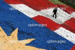 03.04.2009 Kuala Lumpur, Malaysia,  A man sprays the alaysian flag - Formula 1 World Championship, Rd 2, Malaysian Grand Prix, Friday Practice