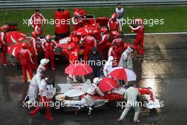 05.04.2009 Kuala Lumpur, Malaysia,  Jarno Trulli (ITA), Toyota Racing passes Felipe Massa (BRA), Scuderia Ferrari after Race stopped due to rain and the cars form up on the grid - Formula 1 World Championship, Rd 2, Malaysian Grand Prix, Sunday Race