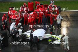 05.04.2009 Kuala Lumpur, Malaysia,  Jenson Button (GBR), Brawn GP passes Felipe Massa (BRA), Scuderia Ferrari after Race stopped due to rain and the cars form up on the grid - Formula 1 World Championship, Rd 2, Malaysian Grand Prix, Sunday Race