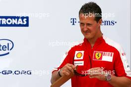 04.04.2009 Kuala Lumpur, Malaysia,  Michael Schumacher (GER), Test Driver, Scuderia Ferrari goes to the BMW Sauber F1 Team office with Dr. Mario Theissen (GER), BMW Sauber F1 Team, BMW Motorsport Director - Formula 1 World Championship, Rd 2, Malaysian Grand Prix, Saturday