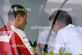 Michael Schumacher (GER), Test Driver, Scuderia Ferrari goes to the BMW Sauber F1 Team office with Dr. Mario Theissen (GER), BMW Sauber F1 Team, BMW Motorsport Director - Formula 1 World Championship, Rd 2, Malaysian Grand Prix, Saturday