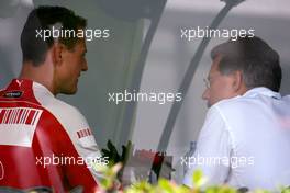 04.04.2009 Kuala Lumpur, Malaysia,  Michael Schumacher (GER), Test Driver, Scuderia Ferrari goes to the BMW Sauber F1 Team office with Dr. Mario Theissen (GER), BMW Sauber F1 Team, BMW Motorsport Director - Formula 1 World Championship, Rd 2, Malaysian Grand Prix, Saturday