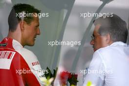 04.04.2009 Kuala Lumpur, Malaysia,  Michael Schumacher (GER), Test Driver, Scuderia Ferrari goes to the BMW Sauber F1 Team office with Dr. Mario Theissen (GER), BMW Sauber F1 Team, BMW Motorsport Director - Formula 1 World Championship, Rd 2, Malaysian Grand Prix, Saturday