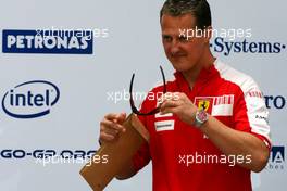 04.04.2009 Kuala Lumpur, Malaysia,  Michael Schumacher (GER), Test Driver, Scuderia Ferrari goes to the BMW Sauber F1 Team office with Dr. Mario Theissen (GER), BMW Sauber F1 Team, BMW Motorsport Director - Formula 1 World Championship, Rd 2, Malaysian Grand Prix, Saturday