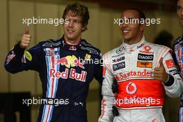 31.10.2009 Abu Dhabi, United Arab Emirates,  Sebastian Vettel (GER), Red Bull Racing with pole position man Lewis Hamilton (GBR), McLaren Mercedes - Formula 1 World Championship, Rd 17, Abu Dhabi Grand Prix, Saturday Qualifying