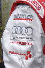 08.06.2009 Le Mans, France, Porsche badge on sleeve of Romain Dumas  - 24 Hour of Le Mans 2009, Monday