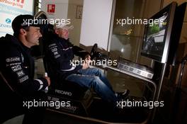13-16.05.2010 Nurburgring, Germany,  Uwe Alzen plays with the race sims in the media center while Pedro Lamy looks on - Nurburgring 24 Hours 2010