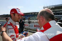 24.04.2010 Hockenheim, Germany,  Dr. Ullrich (AUT), Audi motorsport director, congratulates Martin Tomczyk (GER), Audi Sport Team Abt, Portrait with his 2nd place in qualifying - DTM 2010 at Hockenheimring, Hockenheim, Germany