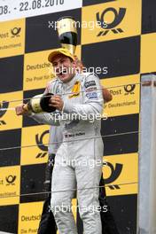 22.08.2010 Zandvoort, The Netherlands,  Racewinner Gary Paffett (GBR), Team HWA AMG Mercedes, AMG Mercedes C-Klasse receives a champagne shower on the podium after his victory. - DTM 2010 at Circuit Park Zandvoort, The Netherlands