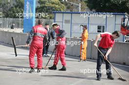 26.11.2010 Shanghai, China,  Team Members are cleaning the Entrance of the Pitlane - DTM 2010 at Hockenheimring