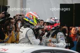 28.11.2010 Shanghai, China,  Paul di Resta (GBR), Team HWA AMG Mercedes, AMG Mercedes C-Klasse and Gary Paffett (GBR), Team HWA AMG Mercedes, AMG Mercedes C-Klasse celebrate the Championship and Victory of the Race - DTM 2010 at Hockenheimring